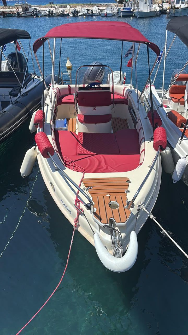 Wind Boat 5.30m front view with red canopy in Skopelos marina